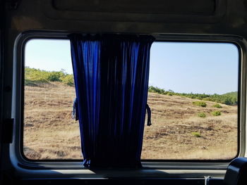 View of landscape seen through train window