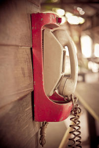 Close-up of telephone booth against wall