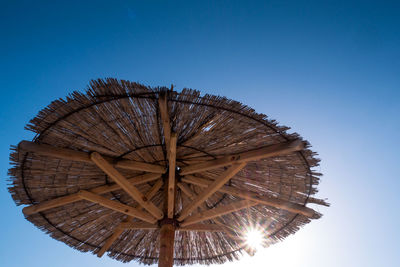 Beach umbrella, view of the beautiful blue sky and straw beach umbrella. perfect holiday concept..