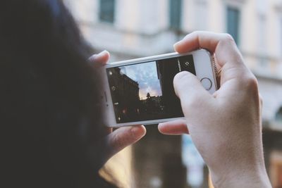 Midsection of man using mobile phone