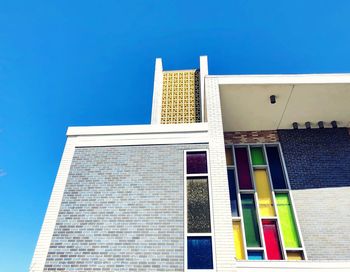 Low angle view of building against blue sky