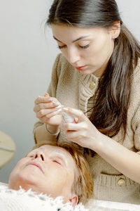 Close-up of young woman sitting at home
