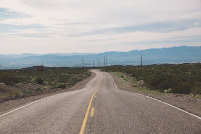 Road amidst landscape against sky