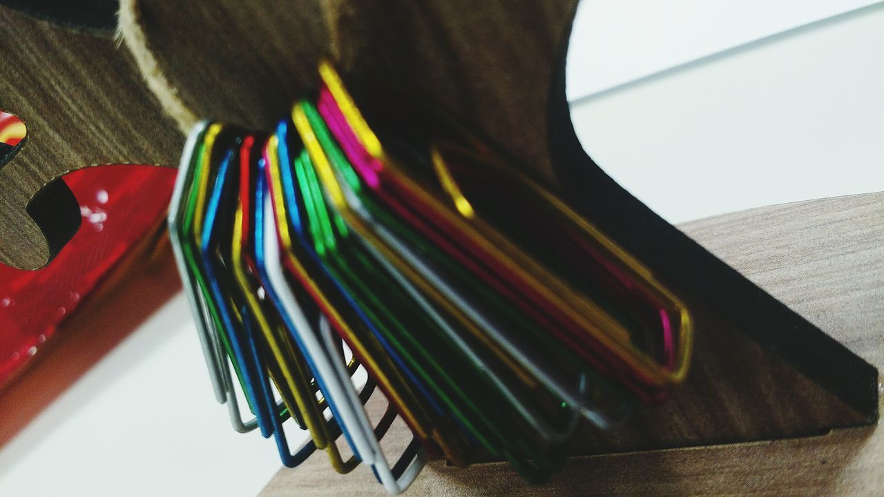 indoors, multi colored, still life, table, variation, colorful, high angle view, close-up, wood - material, no people, arrangement, choice, large group of objects, in a row, art and craft, absence, education, order, book, home interior