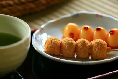 Close-up of glazed on mitarashi dango with sauce