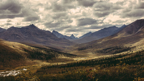 Scenic view of mountains against cloudy sky