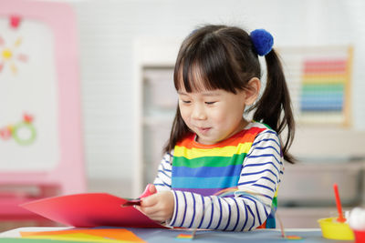 Cute girl playing with toy at home