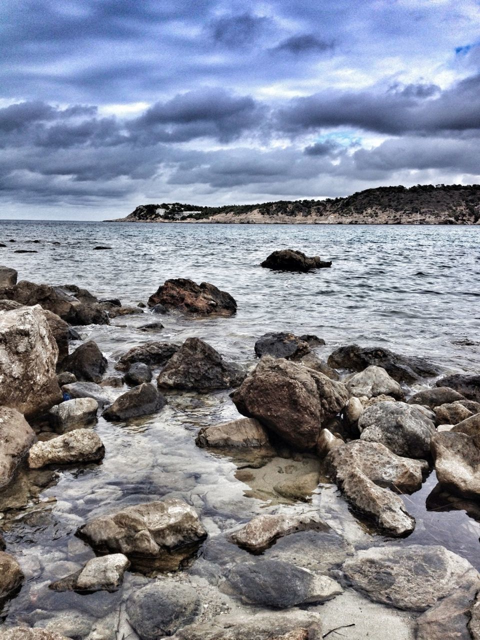 SCENIC VIEW OF ROCKS ON BEACH AGAINST SKY