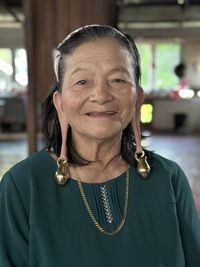 Close-up portrait of young woman wearing sarawak transitional earing