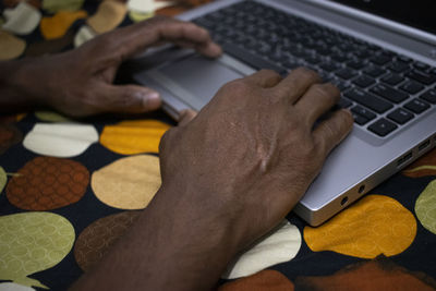 High angle view of man using laptop on table