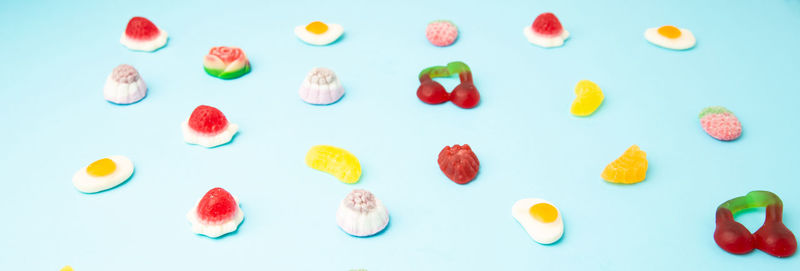 High angle view of multi colored candies against white background