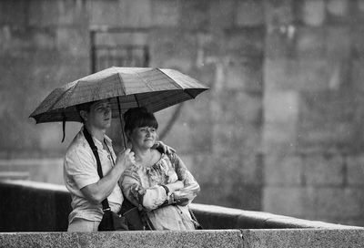 Father and girl holding umbrella