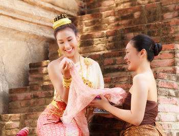 Young female models wearing traditional clothing at brick steps