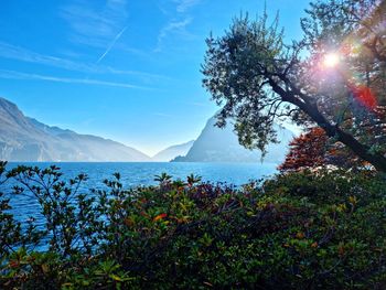 Scenic view of sea and mountains against sky