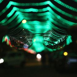 Close-up of illuminated reflection in city at night