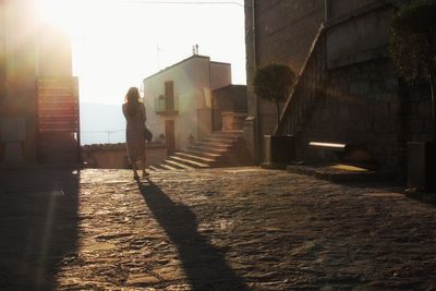 Woman walking on street in city