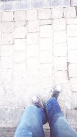 Low section of man standing on tiled floor