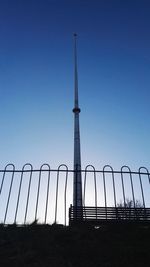 Low angle view of flagpole against clear blue sky at queens park