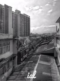 Road amidst buildings against sky in city