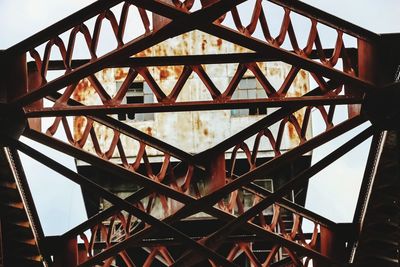 Low angle view of metallic structure against sky