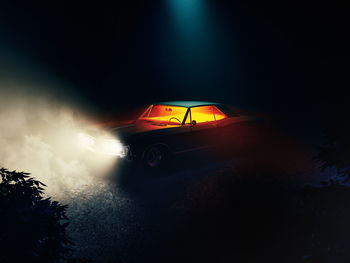 Illuminated car on road at night