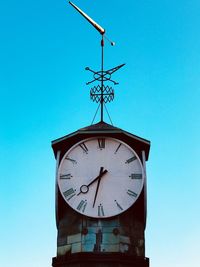 Low angle view of clock tower against clear blue sky