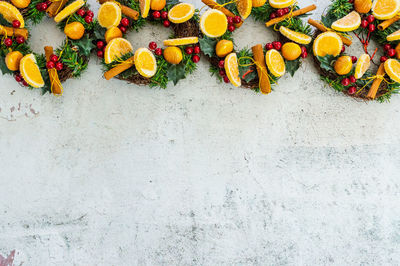 Christmas wreaths as a border on marble-cement grey and white background. 