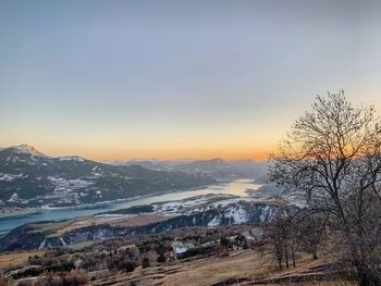 Scenic view of snowcapped mountains against sky during sunset