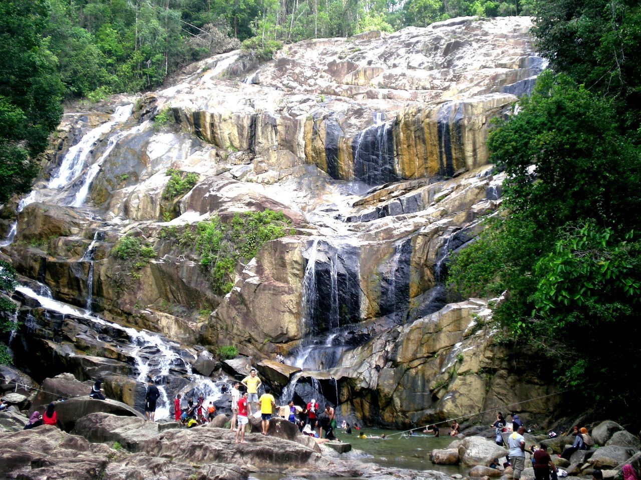 large group of people, nature, travel destinations, rock - object, tree, beauty in nature, real people, outdoors, day, men, waterfall