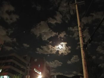 Low angle view of illuminated building against sky at night