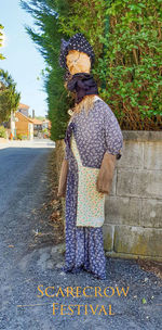 Rear view of woman standing on road