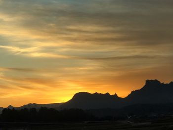 Scenic view of silhouette mountains against sky during sunset