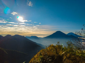 Scenic view of mountains against sky at sunset