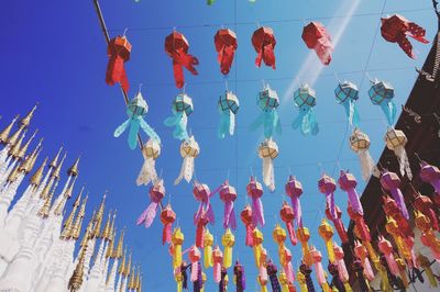 Low angle view of decoration hanging against blue sky