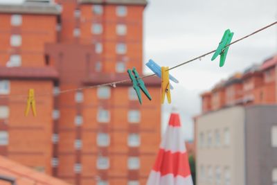 Close-up of clothespins hanging on clothesline