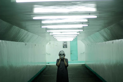 Rear view of man standing in corridor