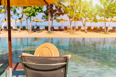Rear view of woman with umbrella on beach