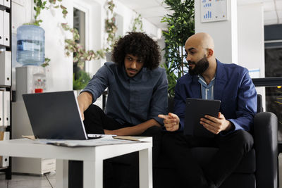 Young woman using laptop at office