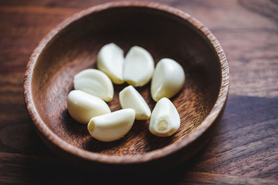 High angle view of garlic cloves in bowl on table