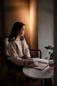 Young woman using laptop at table