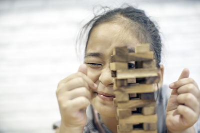 Close-up of girl playing black removal game at home