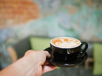 Hand holding coffee cup
