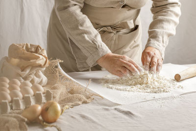 Midsection of woman preparing food at home