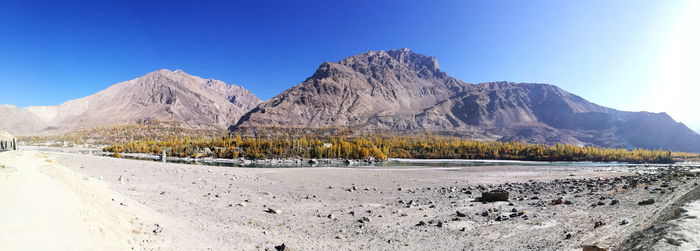 Scenic view of snowcapped mountains against clear blue sky