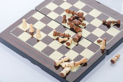 High angle view of chess board over white background