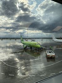 Airplane on runway against sky