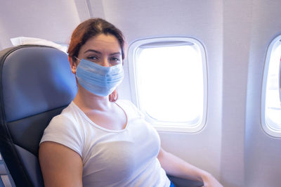 Portrait of woman sitting in airplane