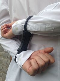 Midsection of man wearing handcuffs