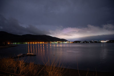 Scenic view of lake against sky at night