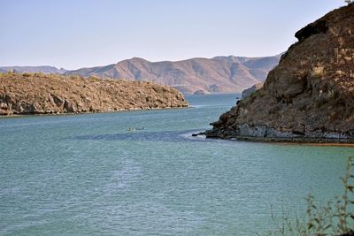 Scenic view of bay against clear sky